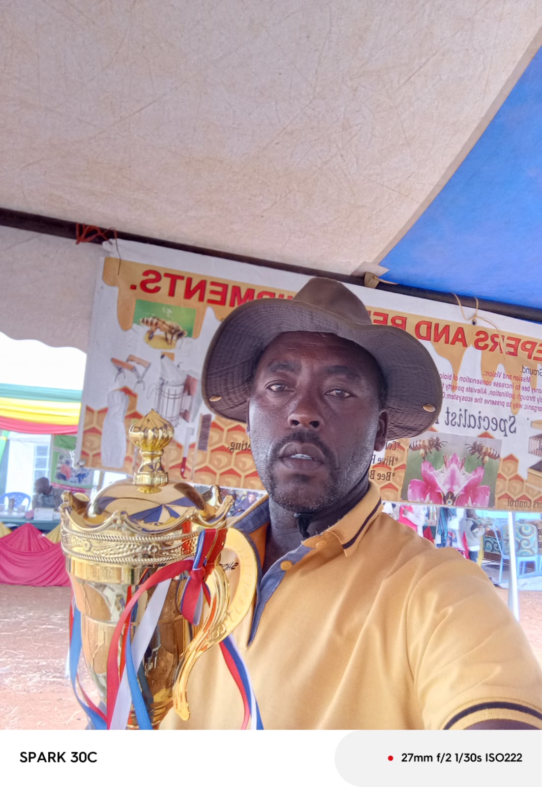 Award winning beekeeper and founder of Sanchez Bee Keepers holding a championship trophy